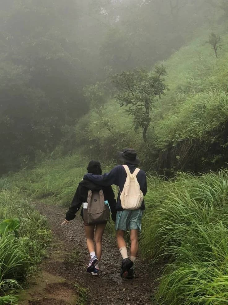 Couple hiking on a misty trail